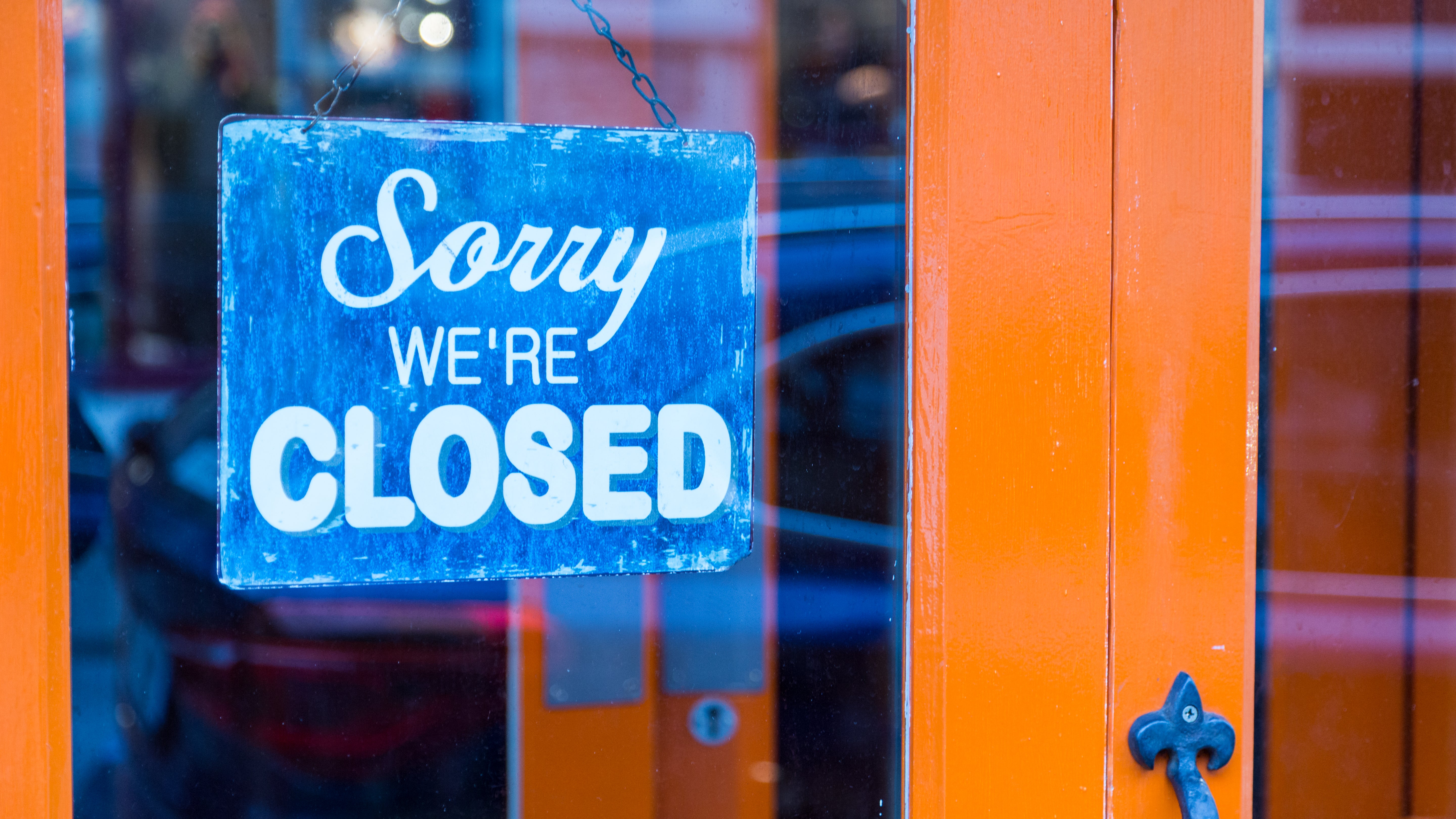 Closed business sign on shop door