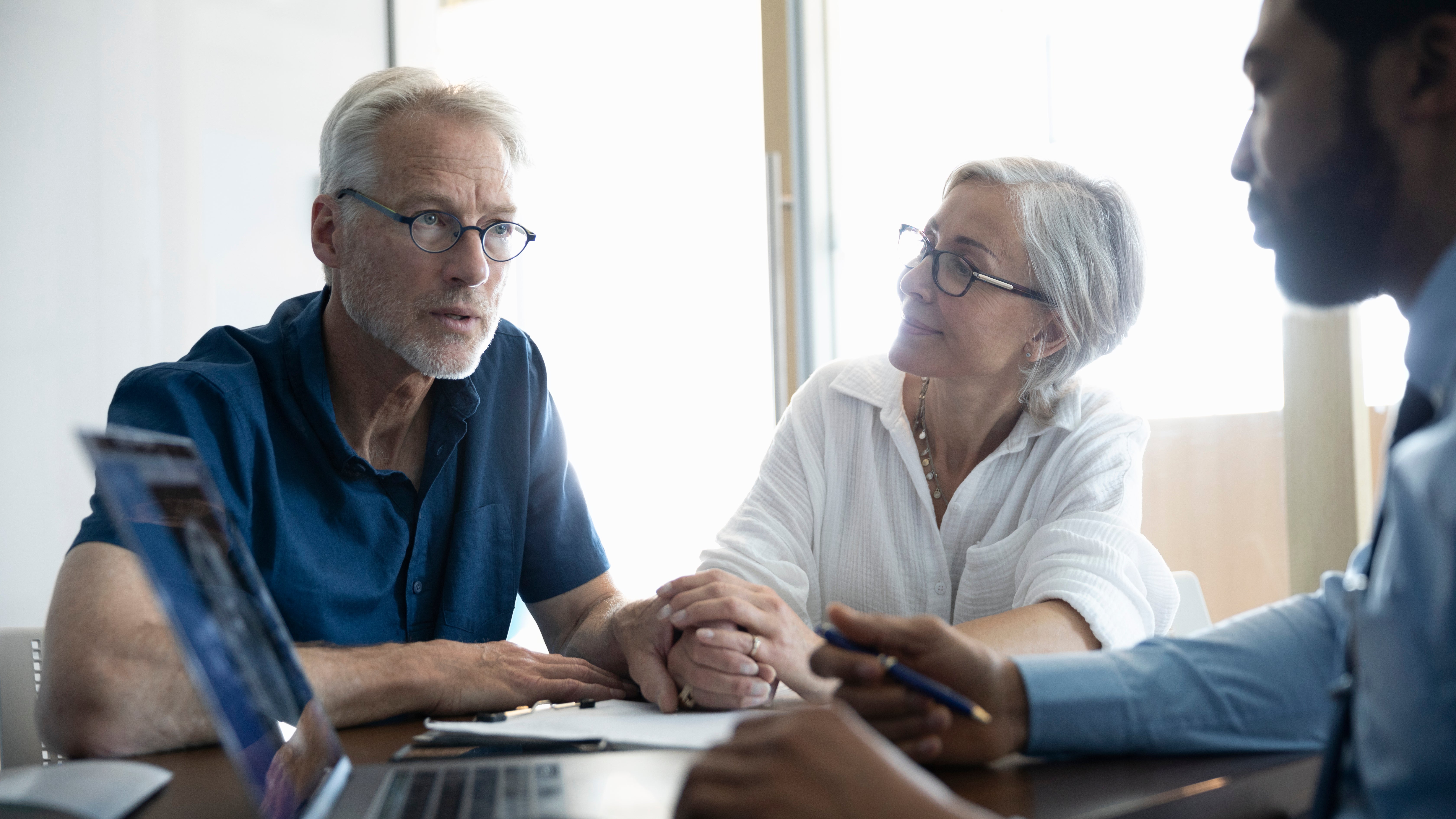 A consultant discussing identity recovery insurance with a senior couple