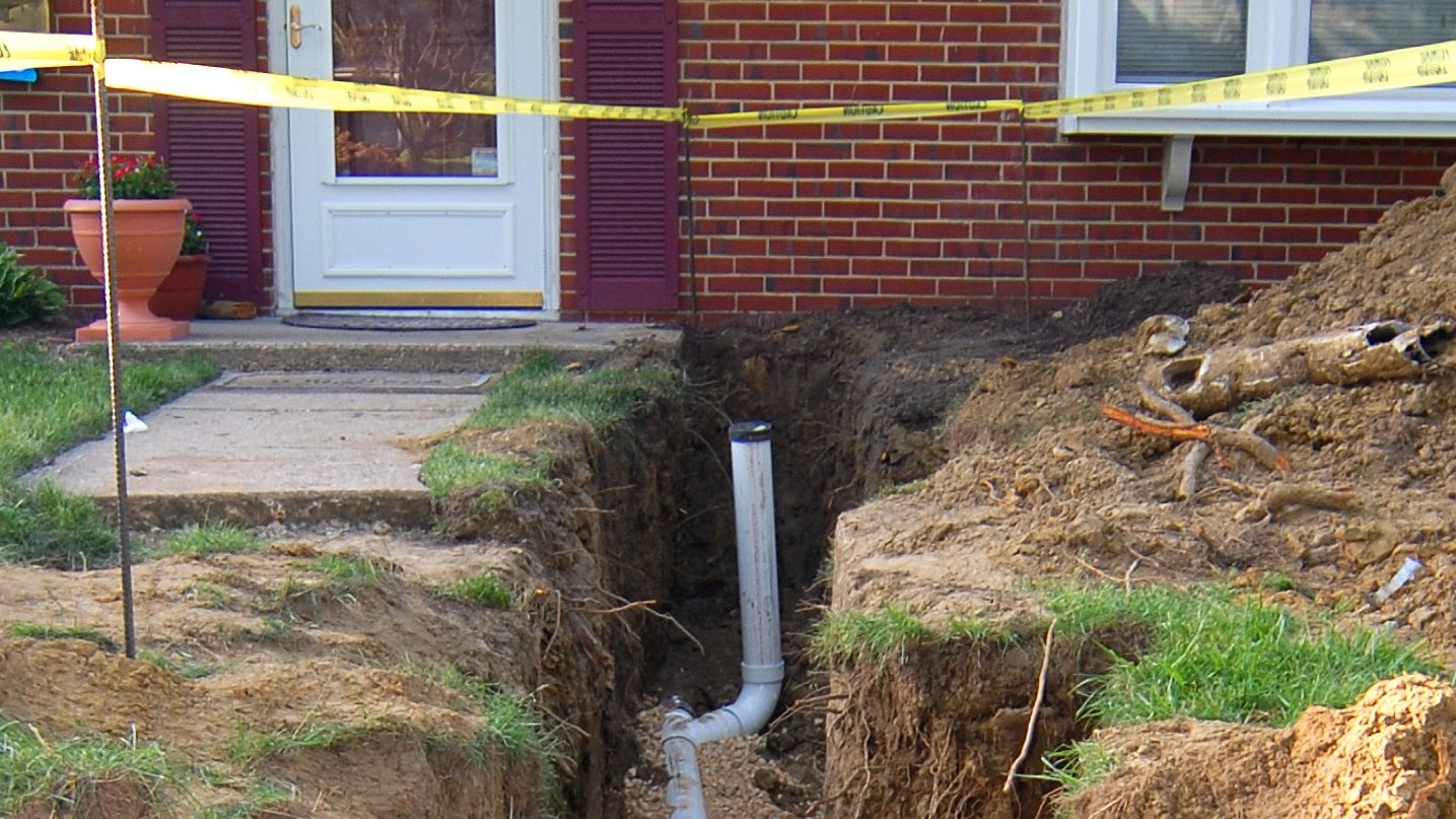 An excavation to repair a home's main septic line