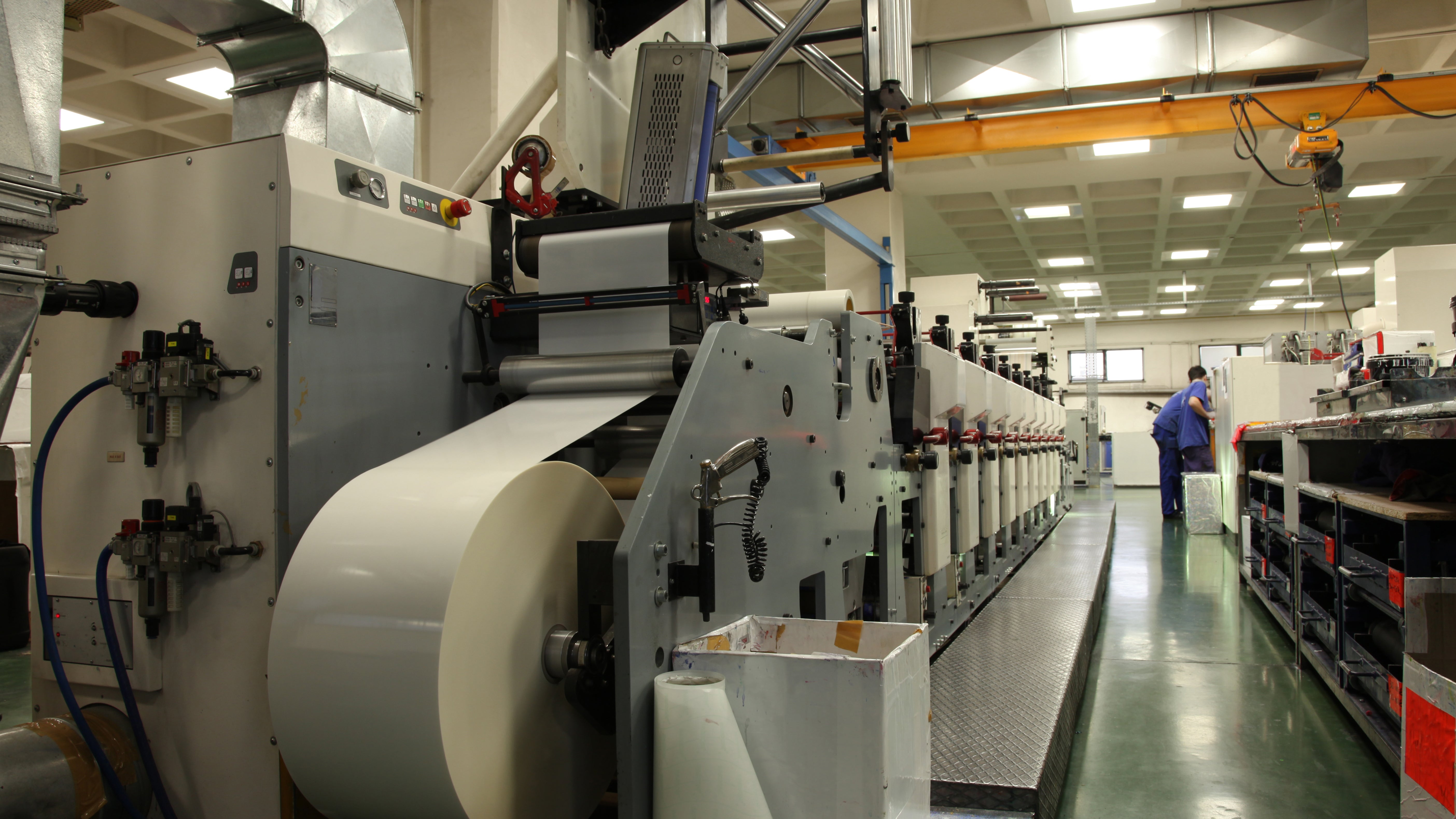 A printing machine with a roll of paper in factory