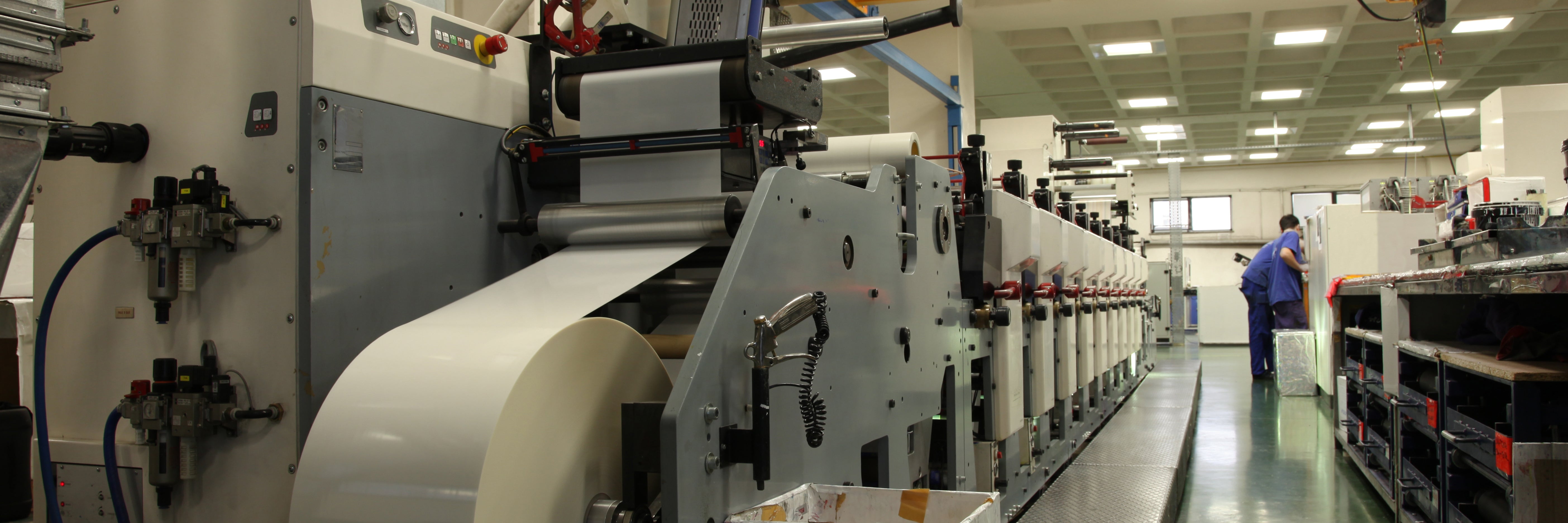 Large printing machine with a roll of paper in factory