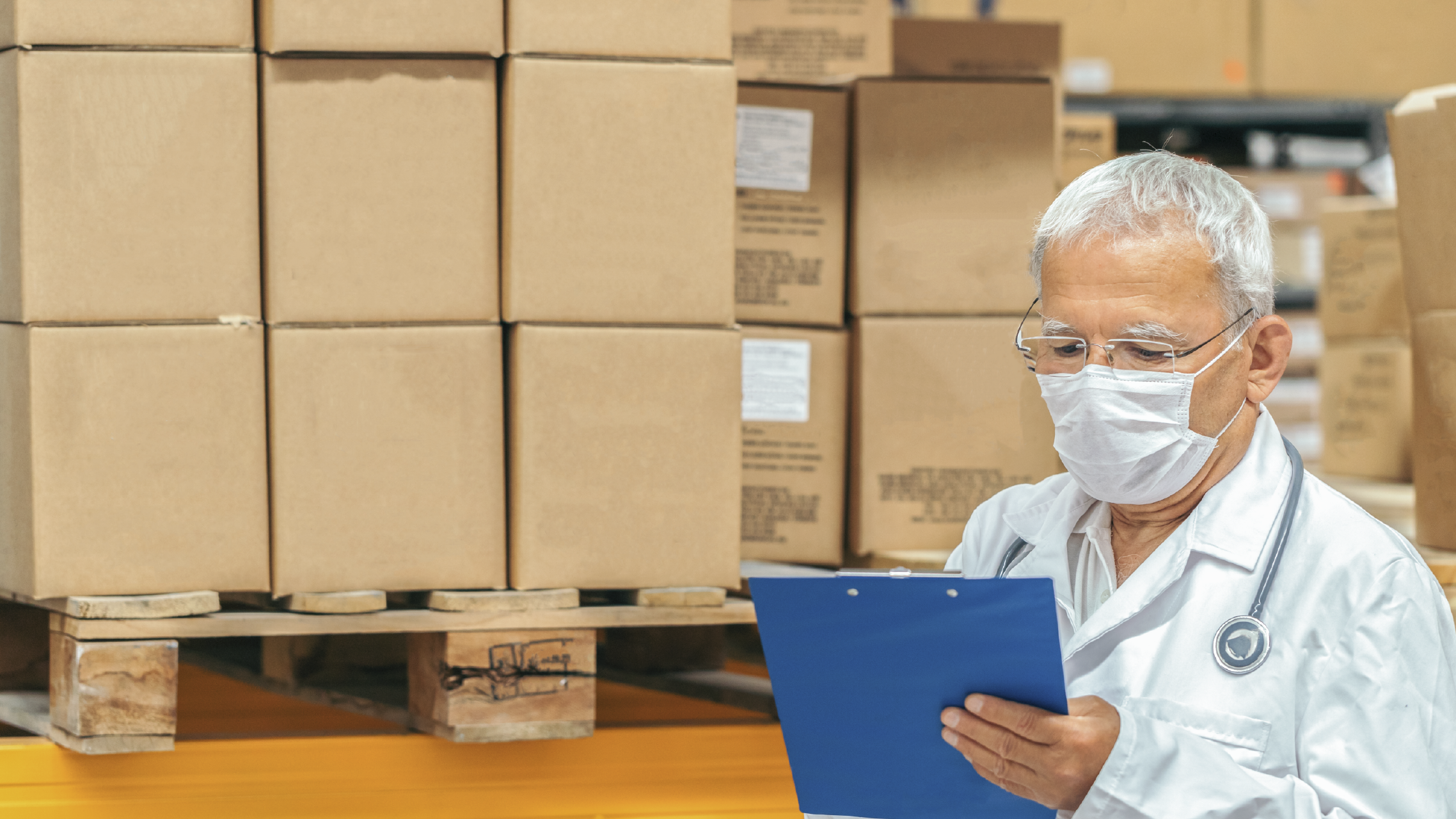 Doctor checking medical supplies in a warehouse