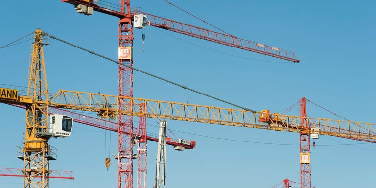 07 Dec 2013, Zürich, Switzerland --- Many construction cranes in front of the blue sky at a large construction site in Zurich, Switzerland --- Image by © Erik Tham/Corbis