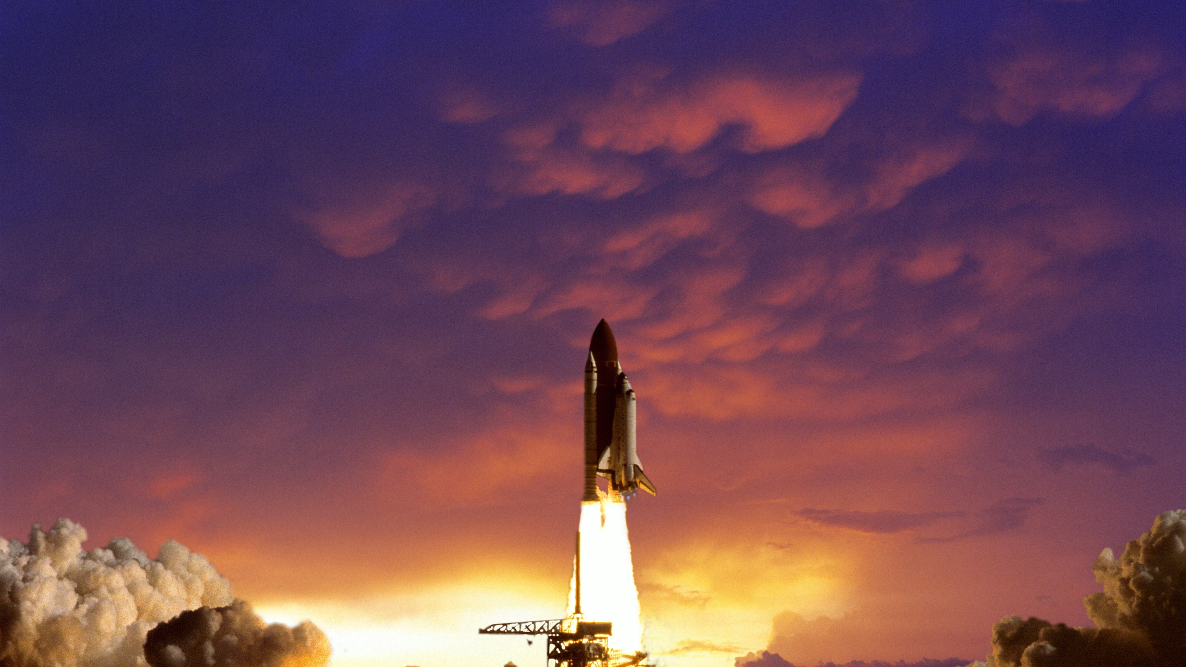 SPACE SHUTTLE LAUNCH AT SUNSET