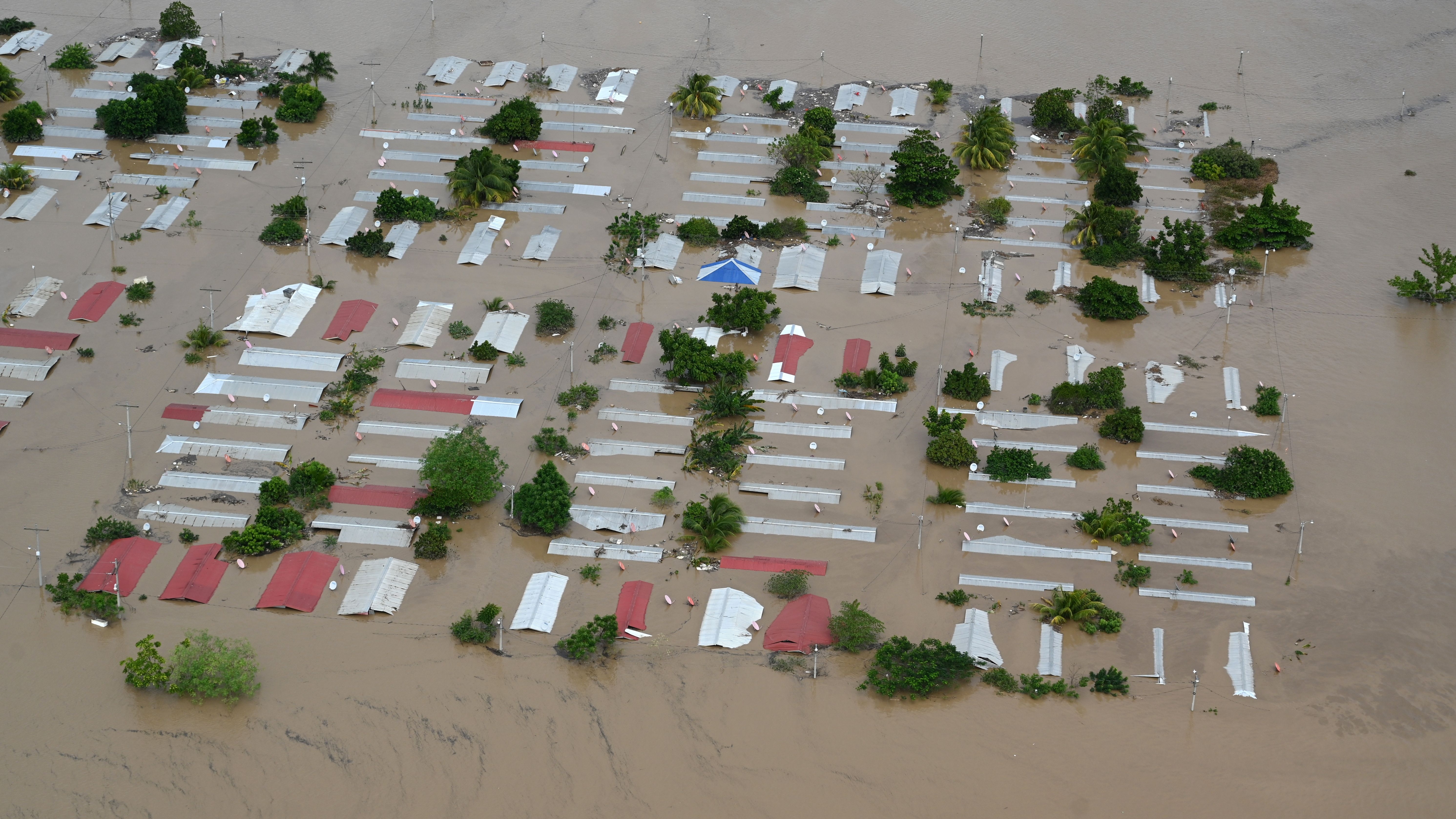 TOPSHOT - Aerial view an area around San Pedro Sula, 240 km north of Tegucigalpa, flooded by the overflowing of the Chamelecon river after the passage of Hurricane Iota, taken on November 18, 2020. - Storm Iota, which made landfall in Nicaragua as a "catastrophic" Category 5 hurricane Monday, killed at least ten people as it smashed homes, uprooted trees and swamped roads during its destructive advance across Central America. (Photo by Orlando SIERRA / AFP) (Photo by ORLANDO SIERRA/AFP via Getty Images)