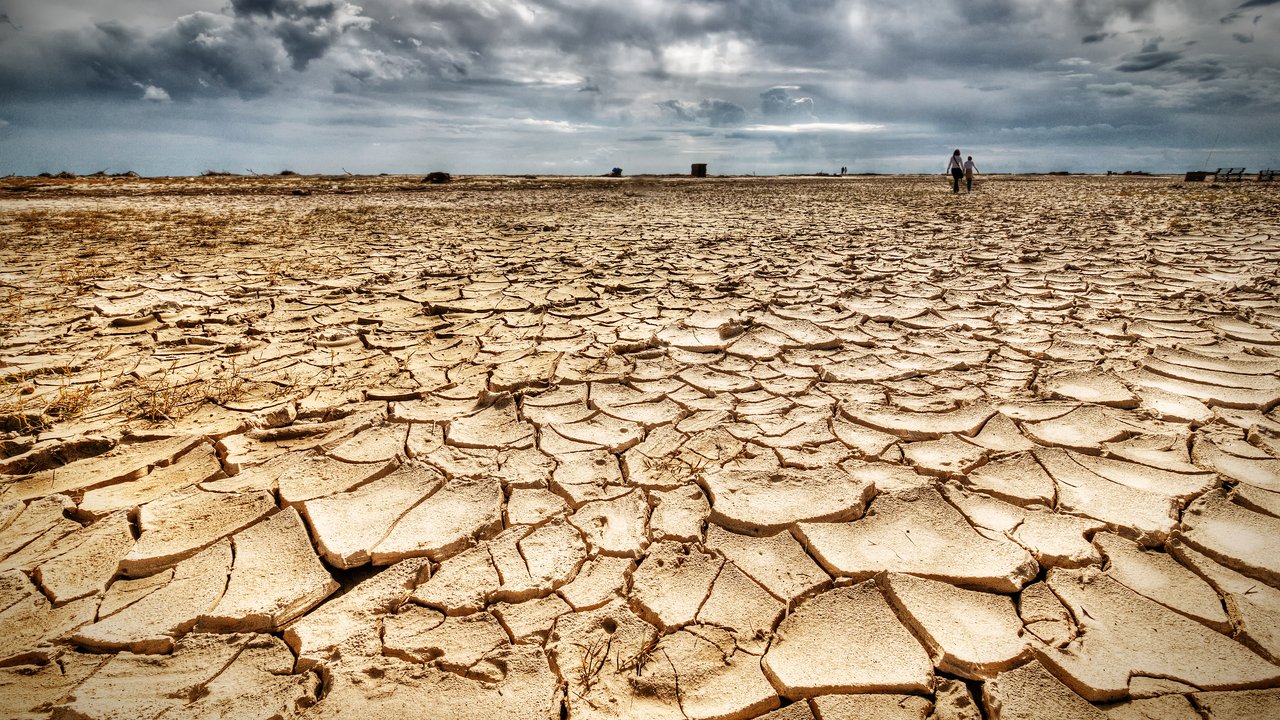 Woman and girl walking on drought.