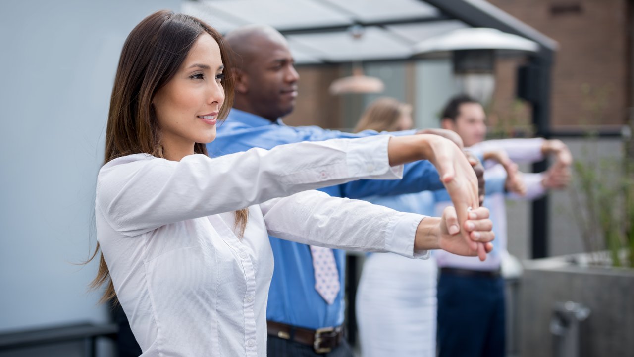 Group of business people stretching during a work break