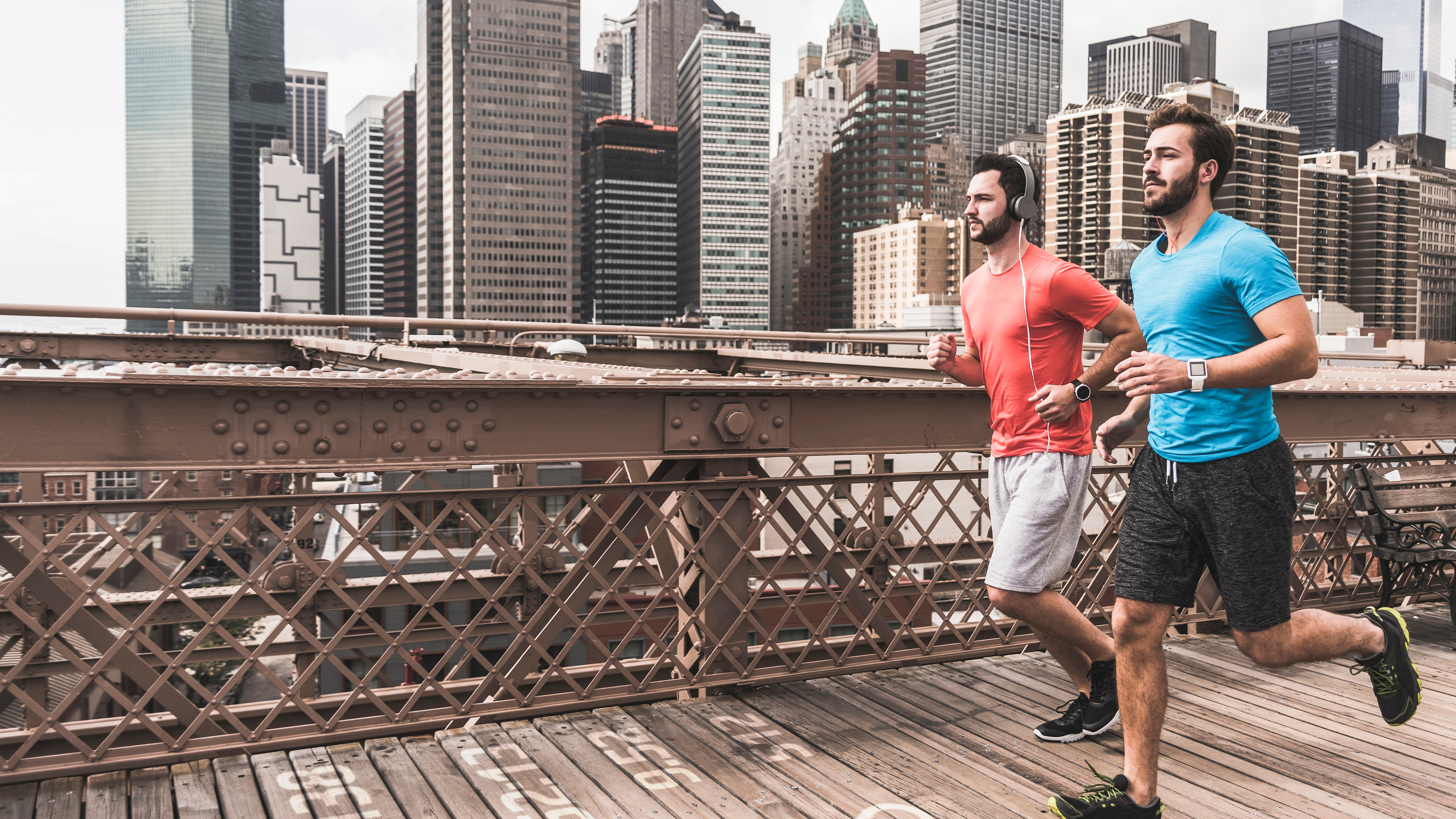 Two men running on the Brooklyn Bridge