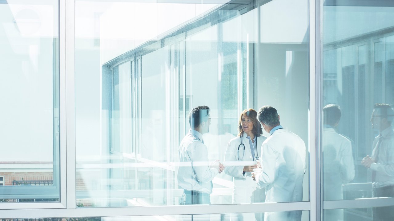 Doctors and administrator in office corridor