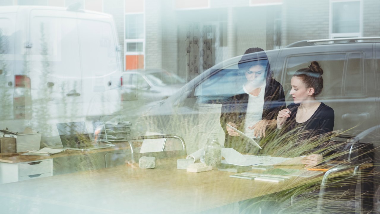 Business executives discussing over digital tablet