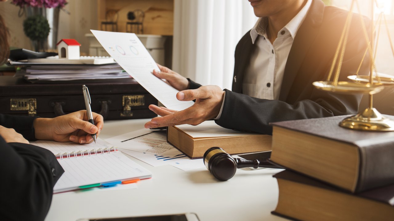 Lawyer in a meeting discussing the latest cases around Critical Illness insurance