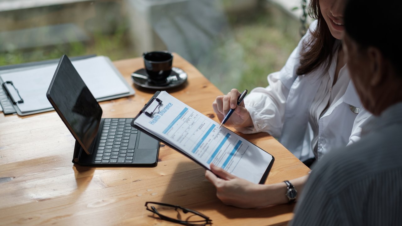 Businesspeople sharing notes during a meeting