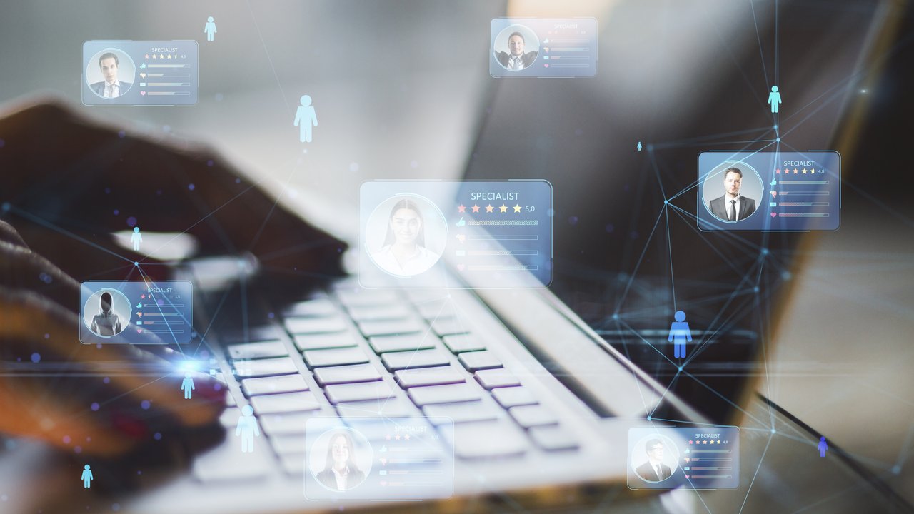 Digital Networking and Specialist Profiles A person typing on a laptop with floating digital profiles and connection lines around them.