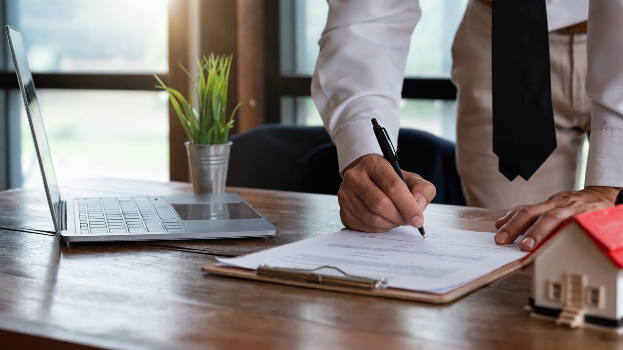 Business professionals in a strategy or brainstorming meeting writing on post it notes