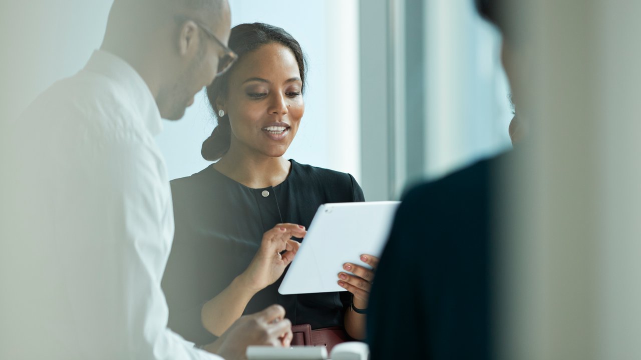 Group of business people standing around office desk