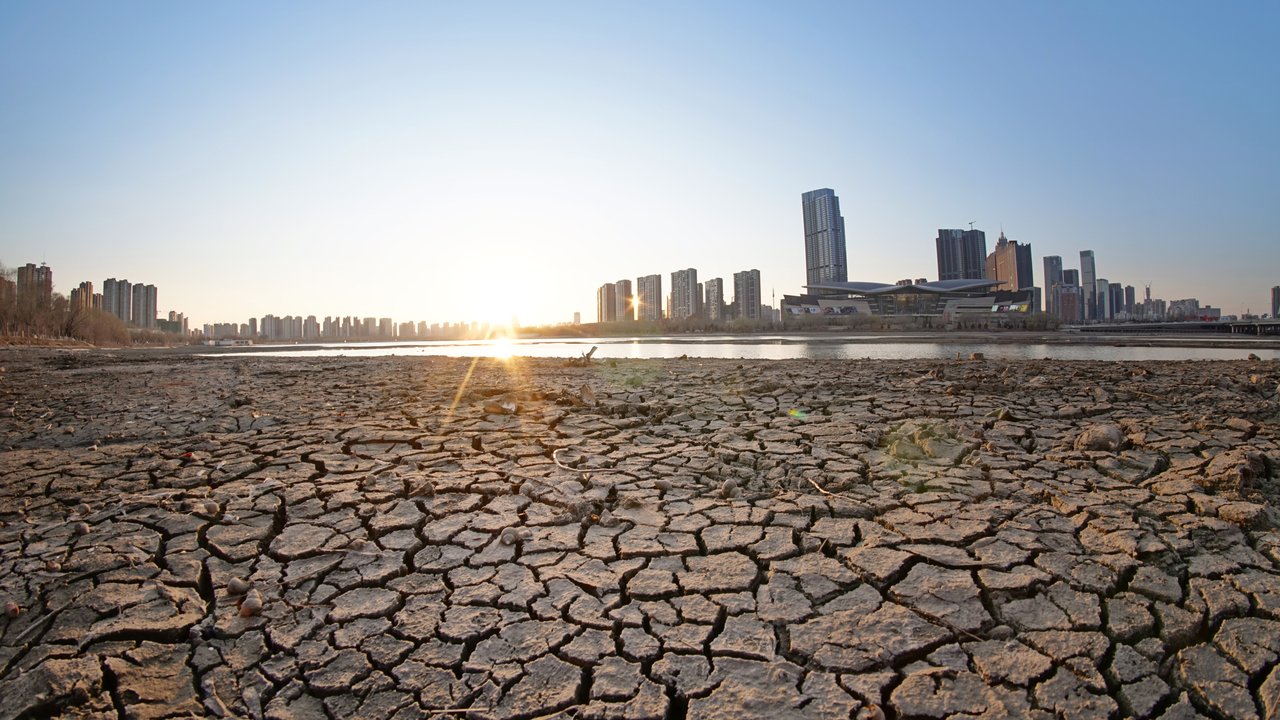 Dried riverbed with city skyline