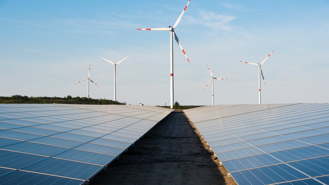 Windmill And Solar Panels On A Blue Sky