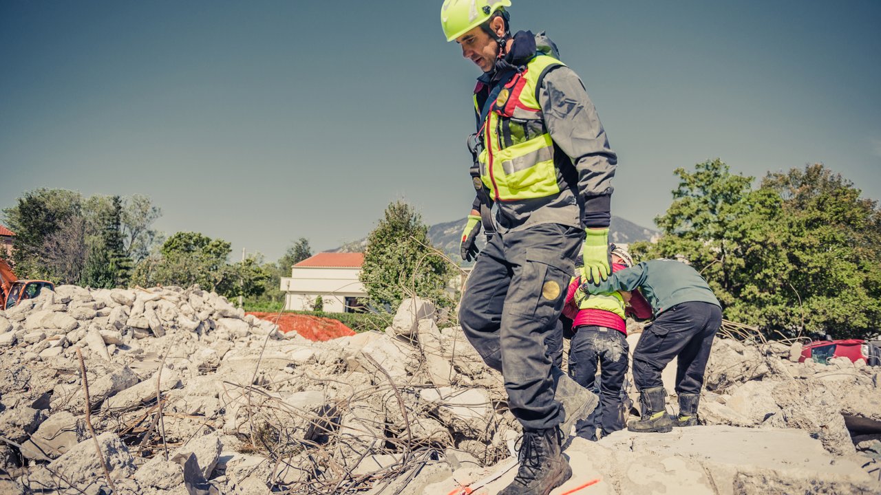 Rescuers search through ruins of building