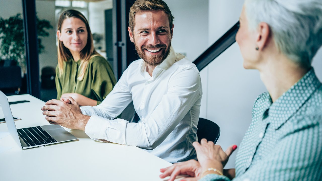 Accelerated underwriting trends: Eligibility limits, digital health data, and the quest for automation Business people listening to the accelerated underwriting survey results in meeting