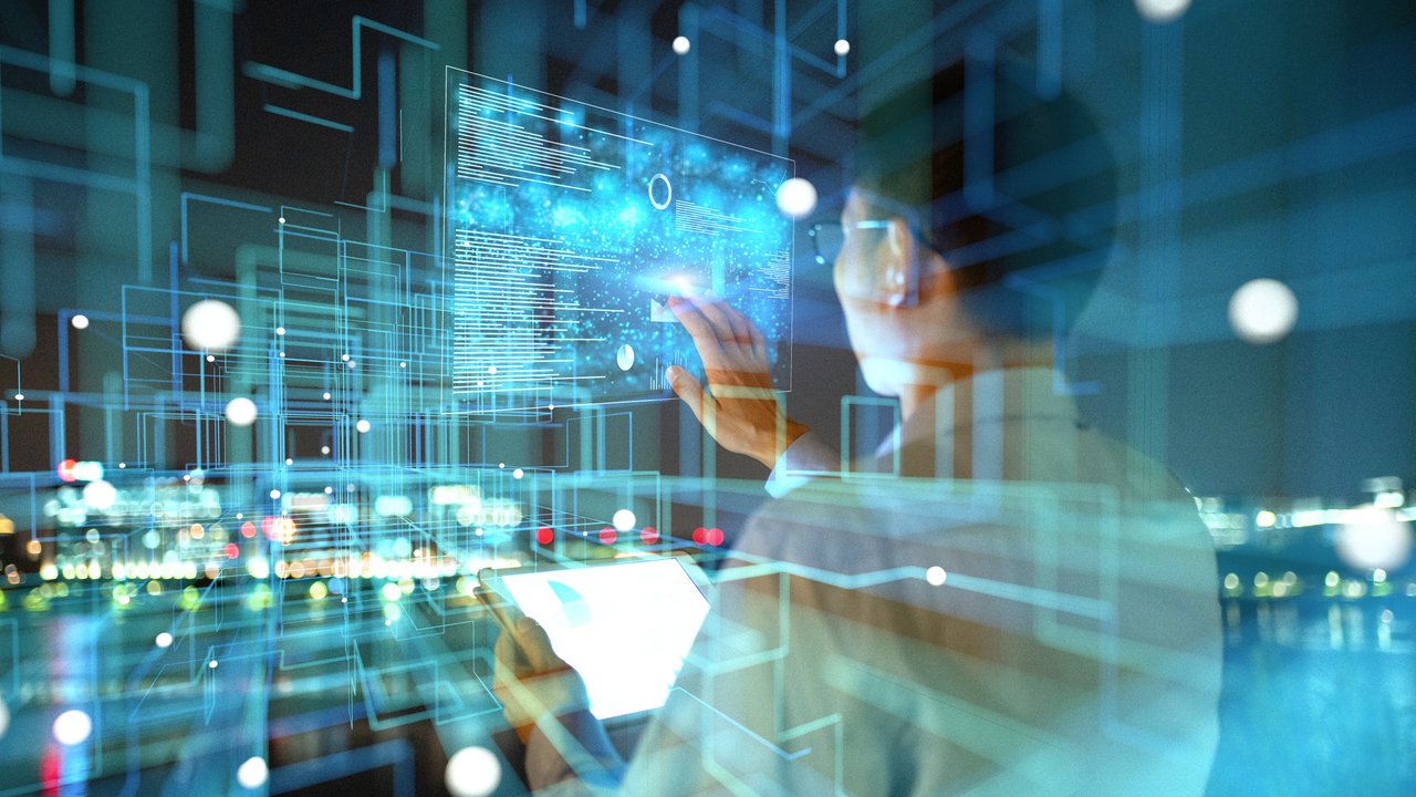 IT technician typing on an interactive screen sorting through EHR data