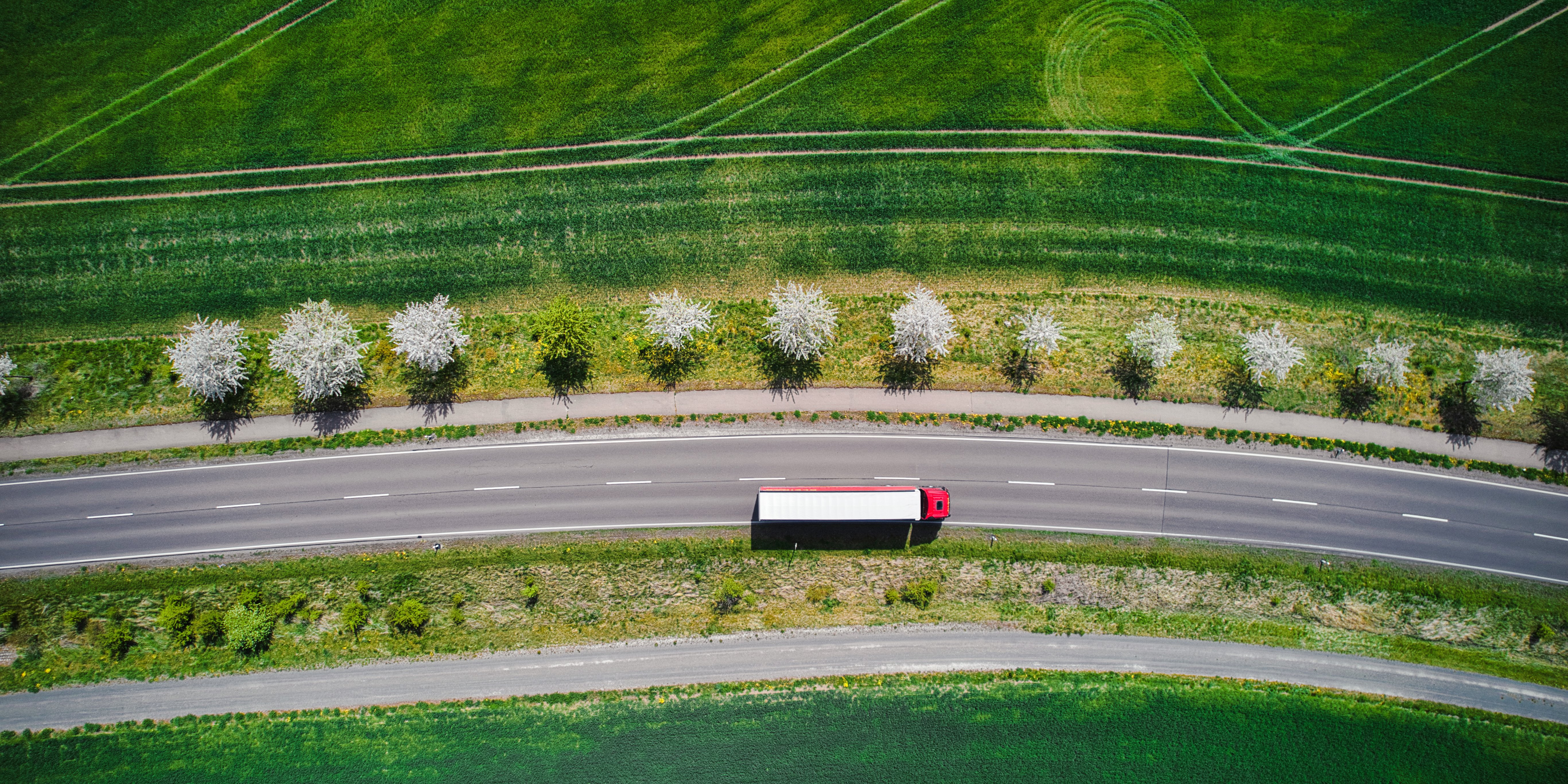 Drone shot directly above a truck moving on a road