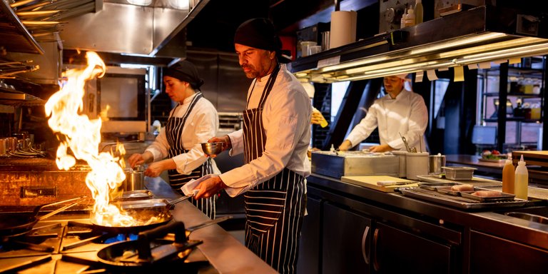 Chef flambéing in a restaurant kitchen