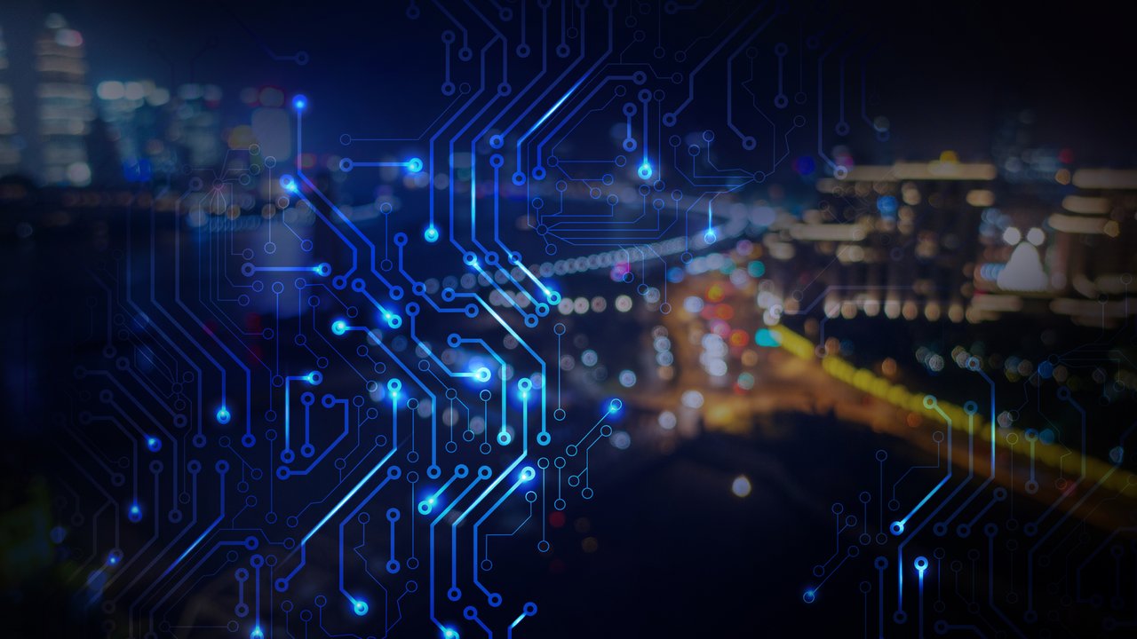 Circuit Pattern Overlay on City Nightscape A blurred city skyline at night with blue circuit patterns overlaying the image.