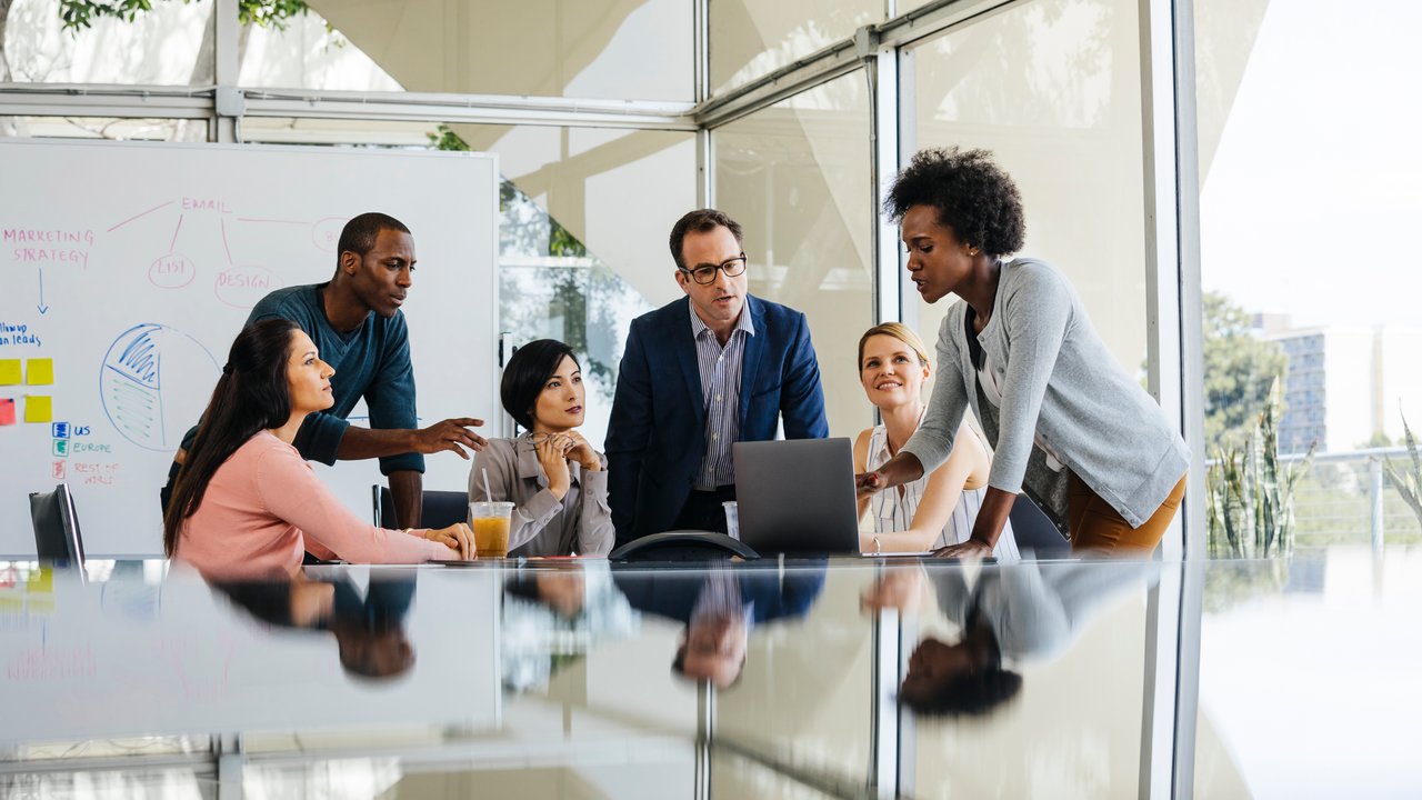 Team discussion over laptop in meeting room Team discussion about the misclassification reasons driving mortality slippage in AUW over laptop in meeting room