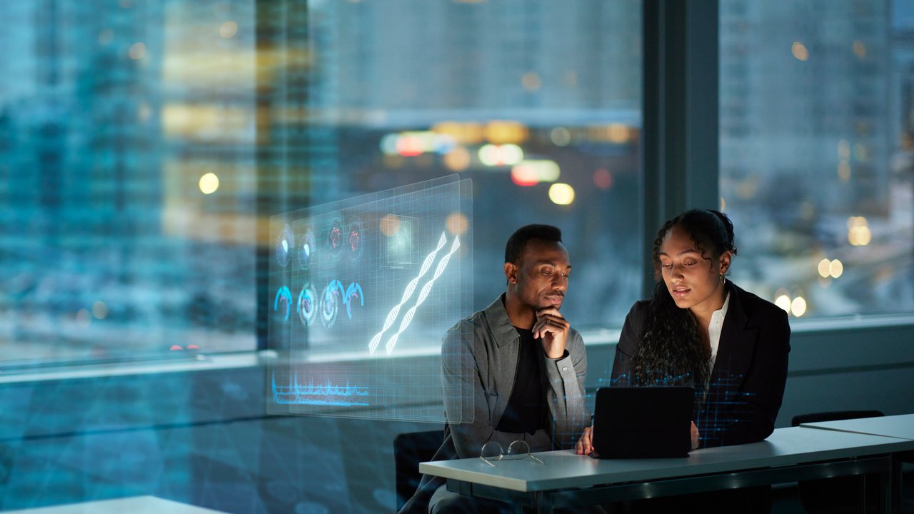 Two Young Business People Working Together in Office Two Young Business People Working Together in Office