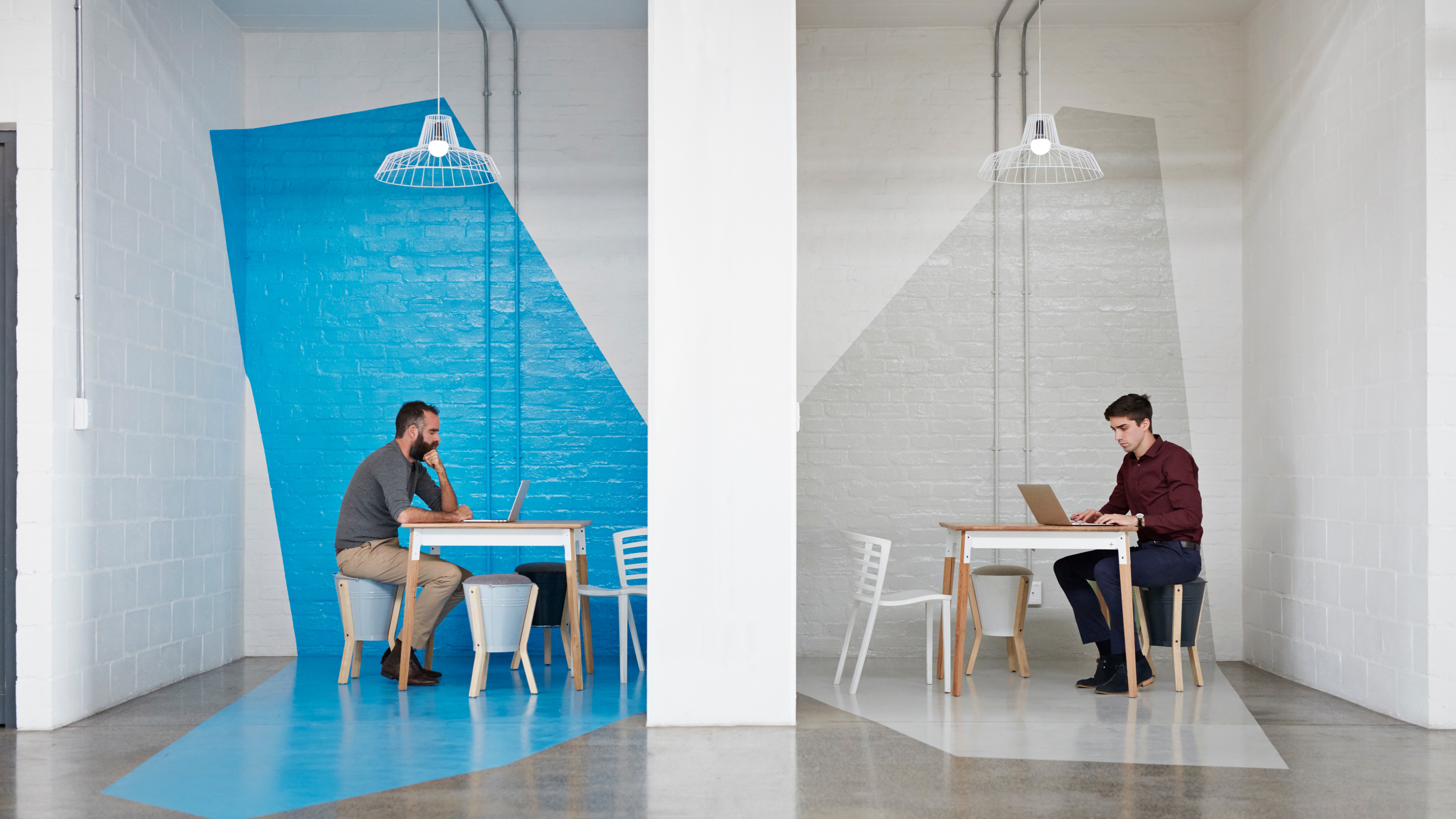 Businesspeople Sitting in Booths at a Big Creative Agency