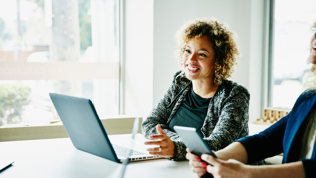 Smiling Businesswoman talking on a Smartphone in an Modern Office