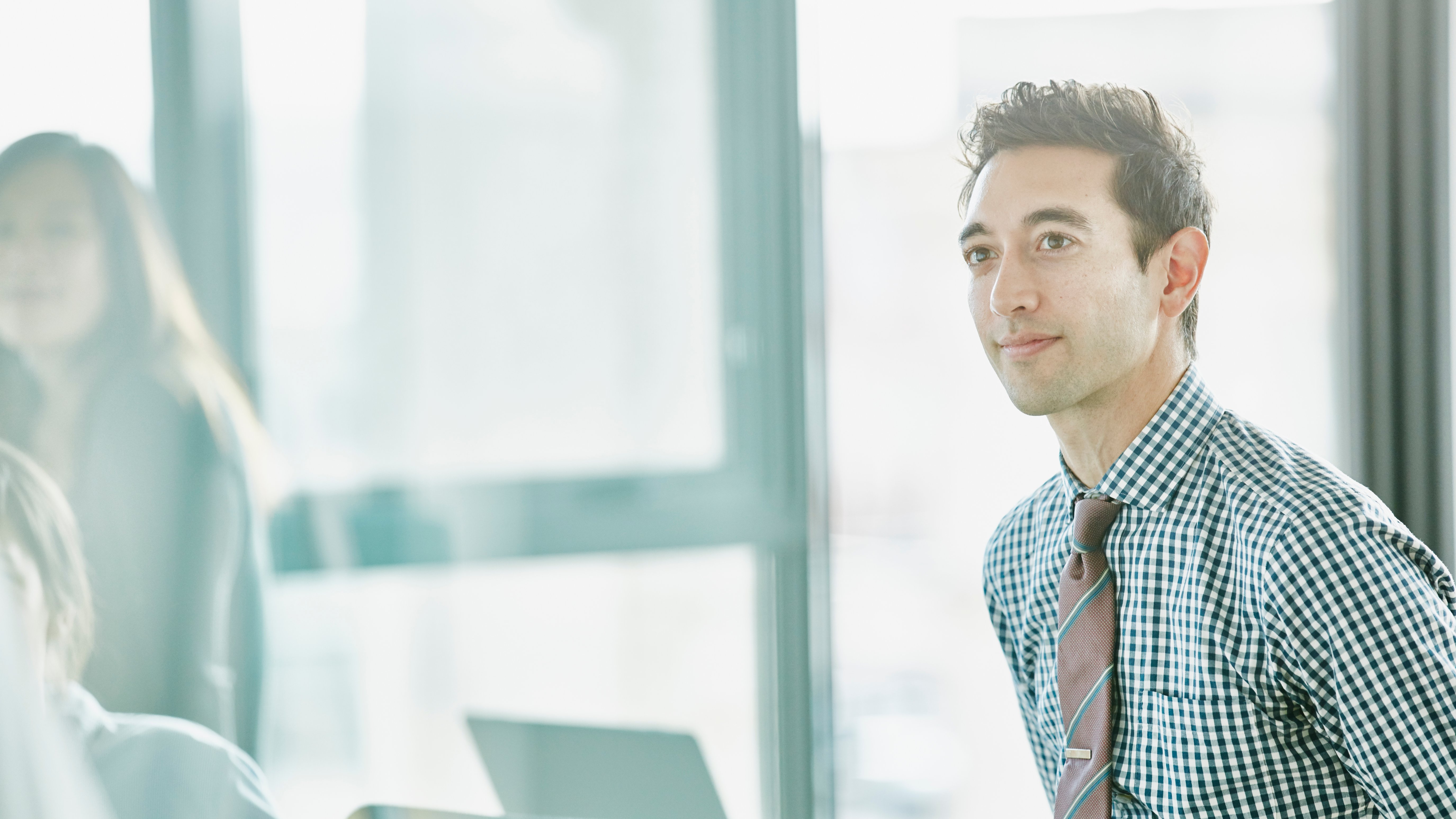 Young professional listening in a meeting discussing the future of underwriting
