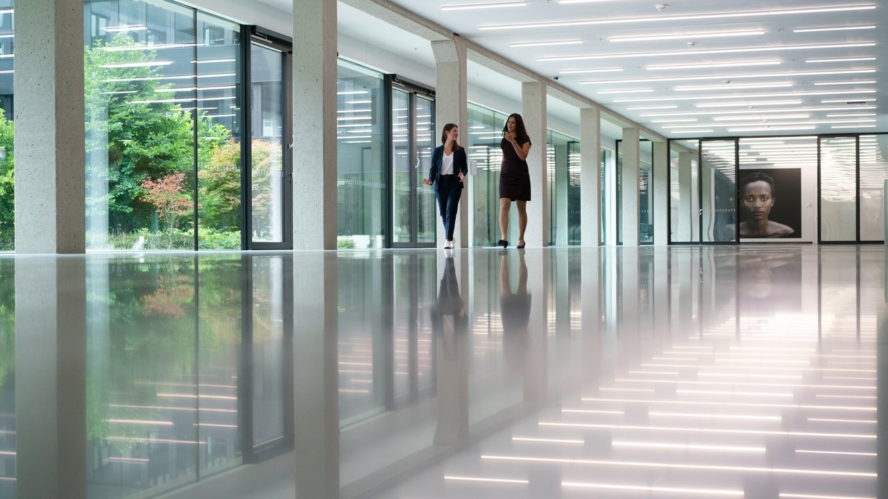 Two businesspeople walking down a hallway 