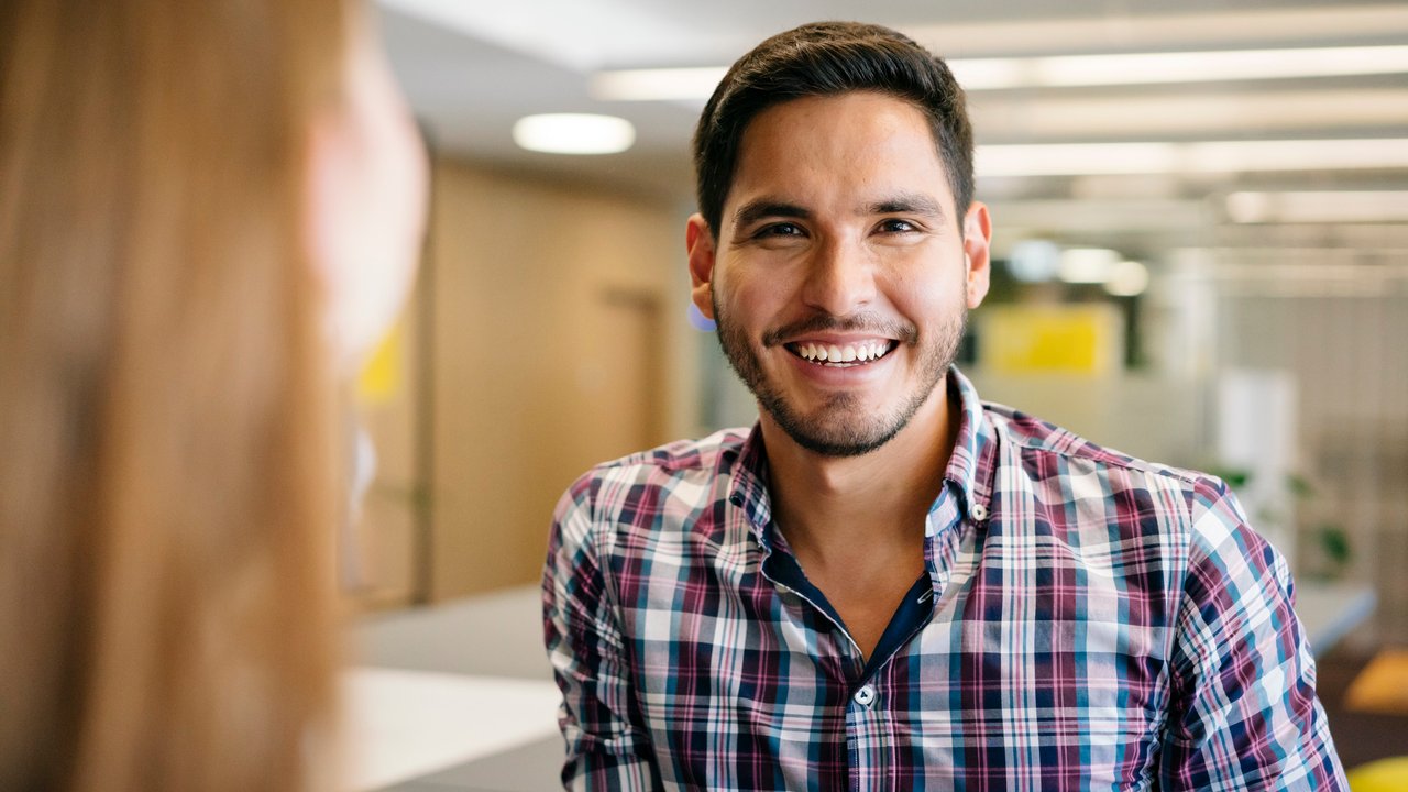 Man smiling at coworker