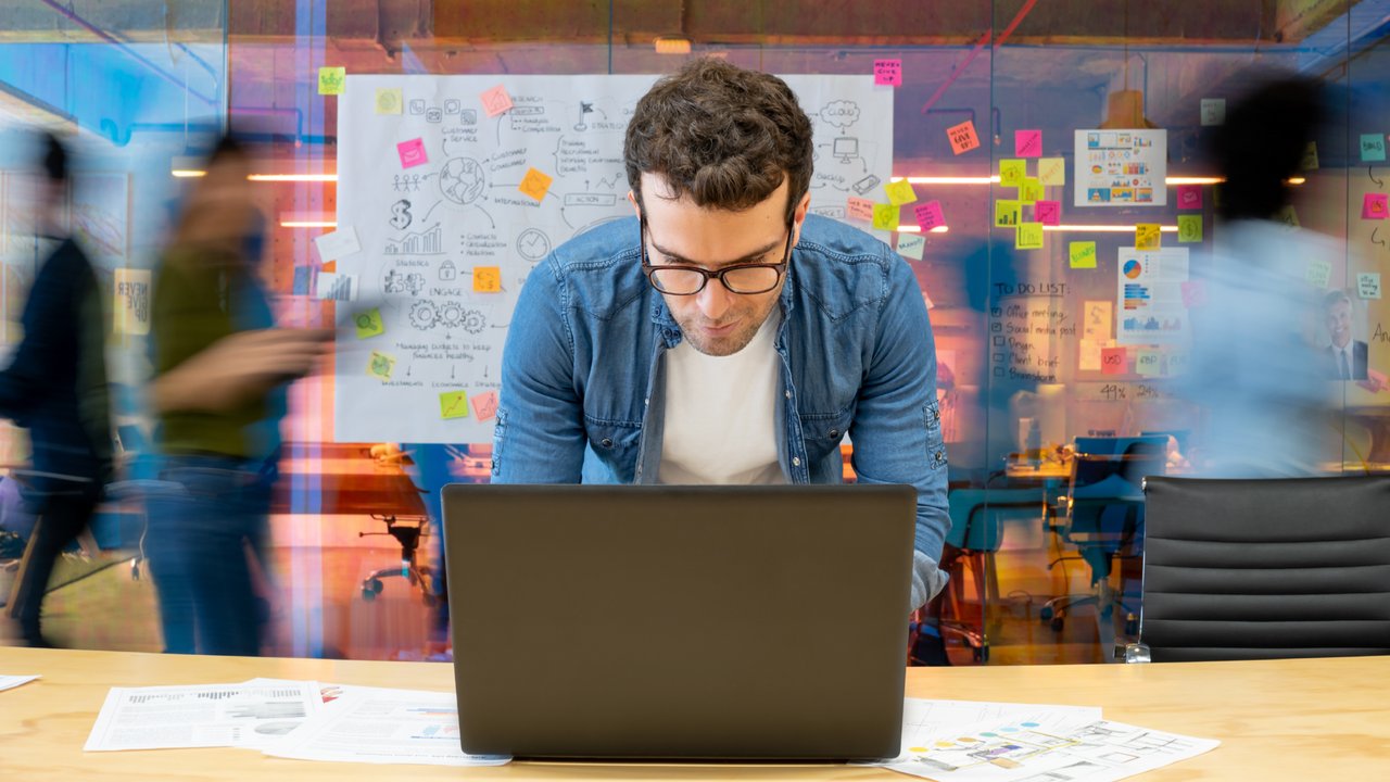 A person working on a cyber risk recovery plan at the office