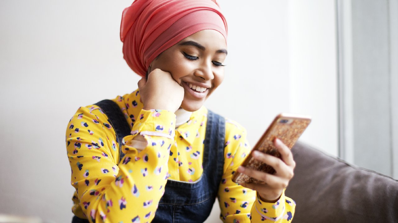 Woman laughing using smartphone