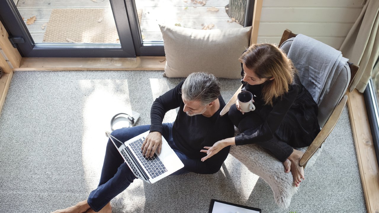 Couple using laptop at home