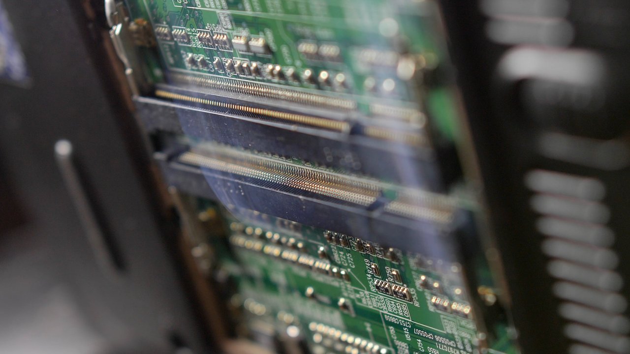 Smoke rising from burnt electronic computer device due to short circuit