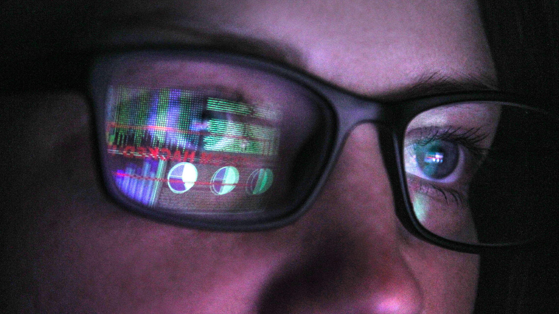 Woman with eye glasses with a computer reflection of data and cyber