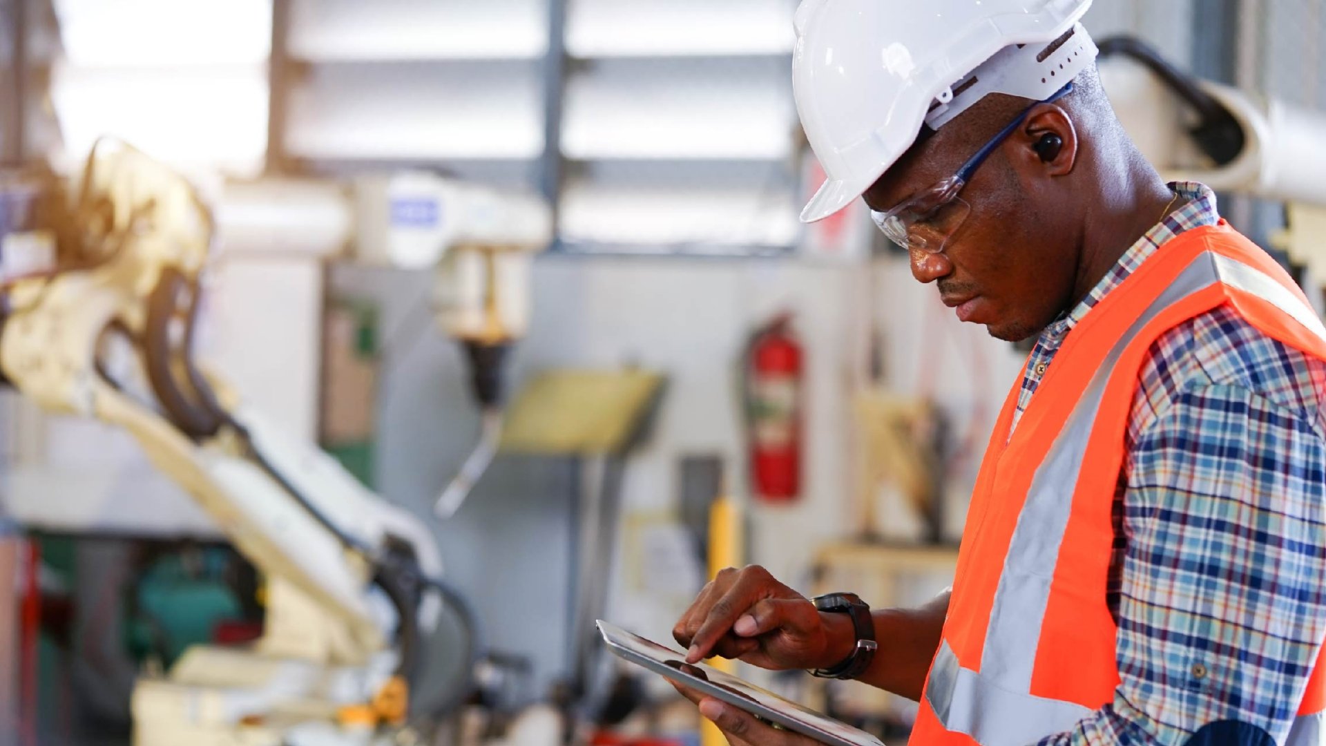Engineer using tablet in a factory