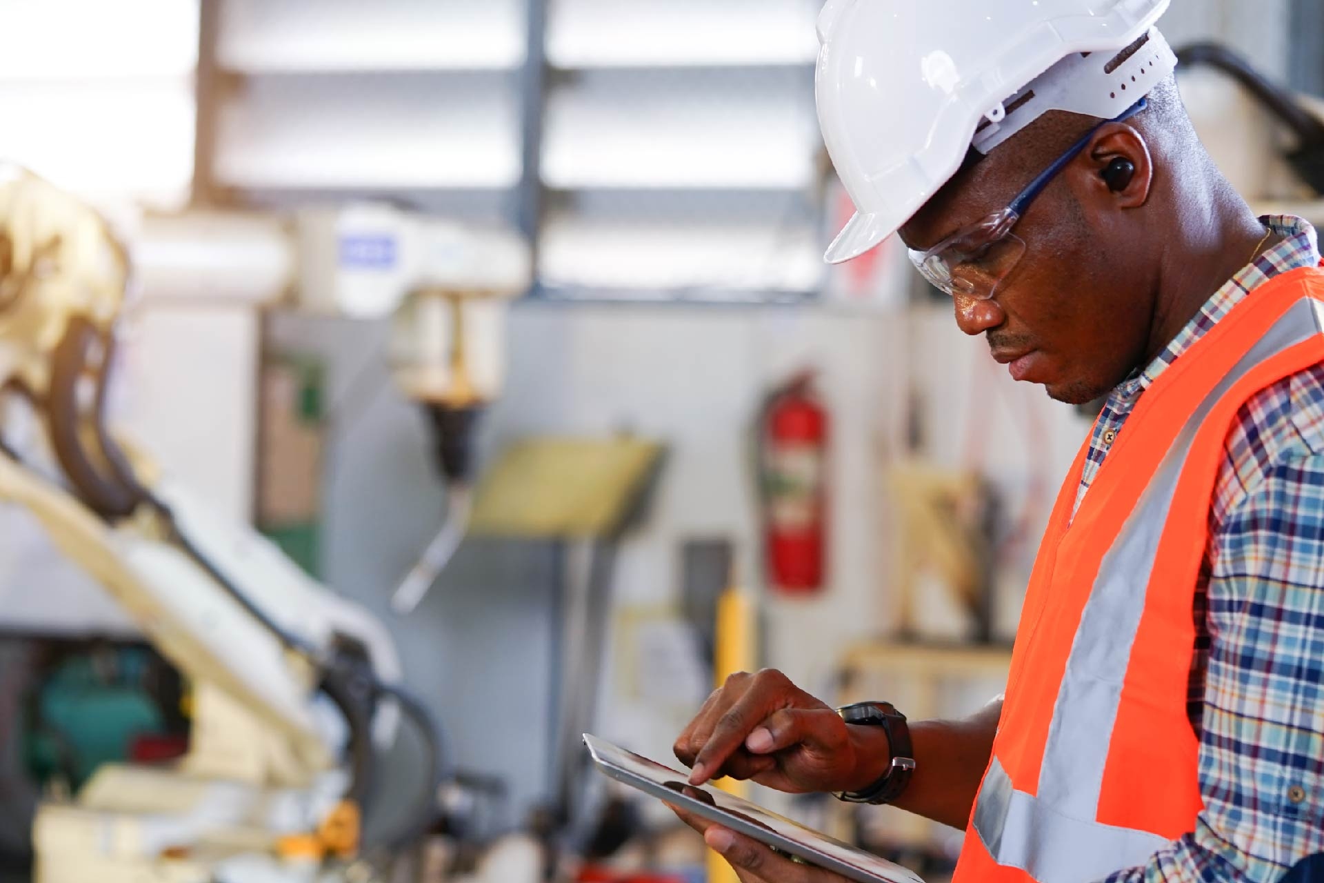 Engineer using tablet in a factory