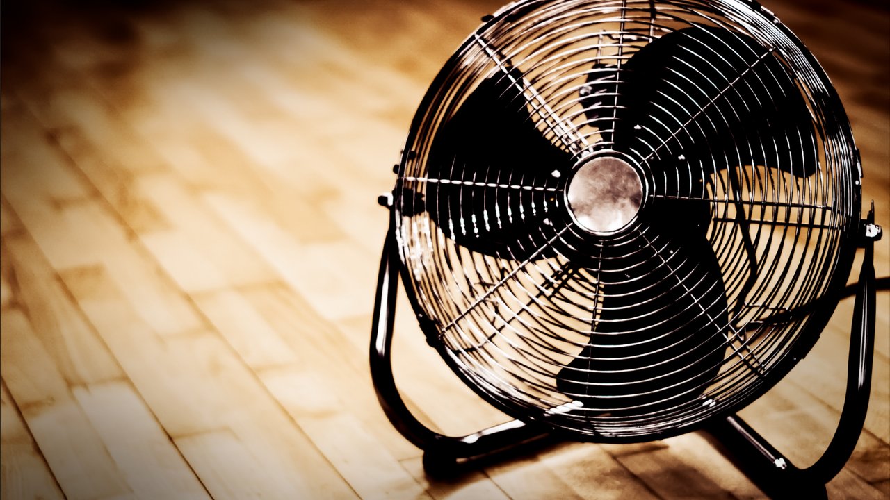 Eletric fan on hardwood floor