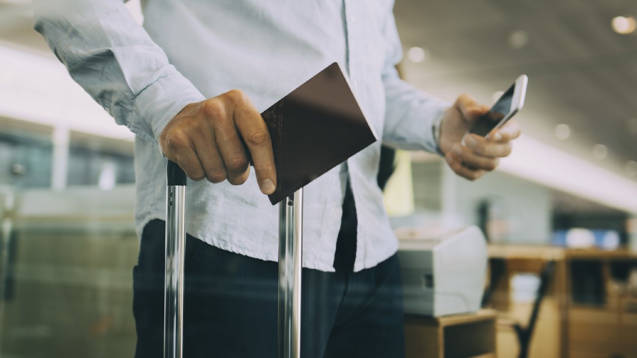 Man holding a passport at the airport
