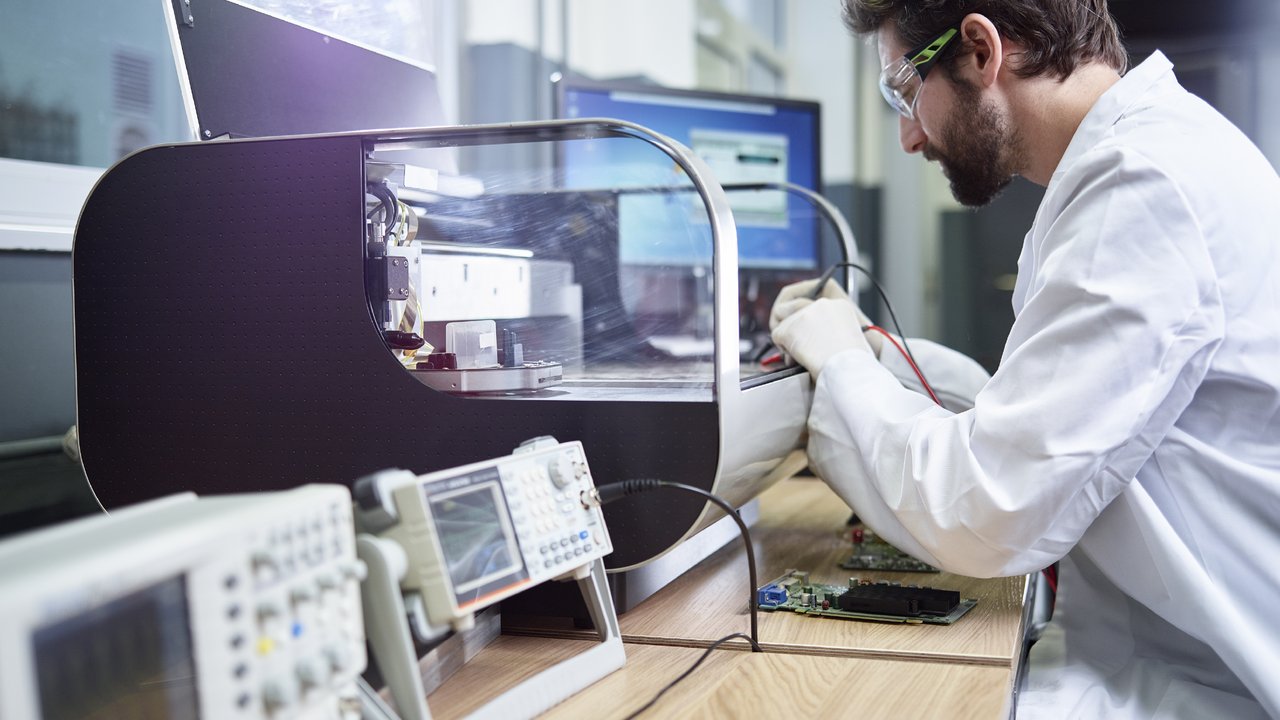 Technician checking 3D printer