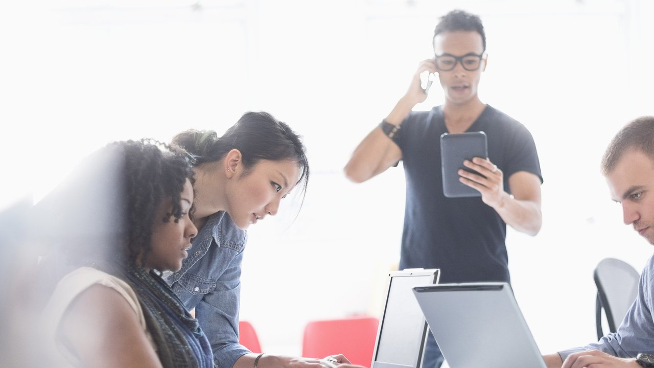 A business meeting between an insurance broker and a client