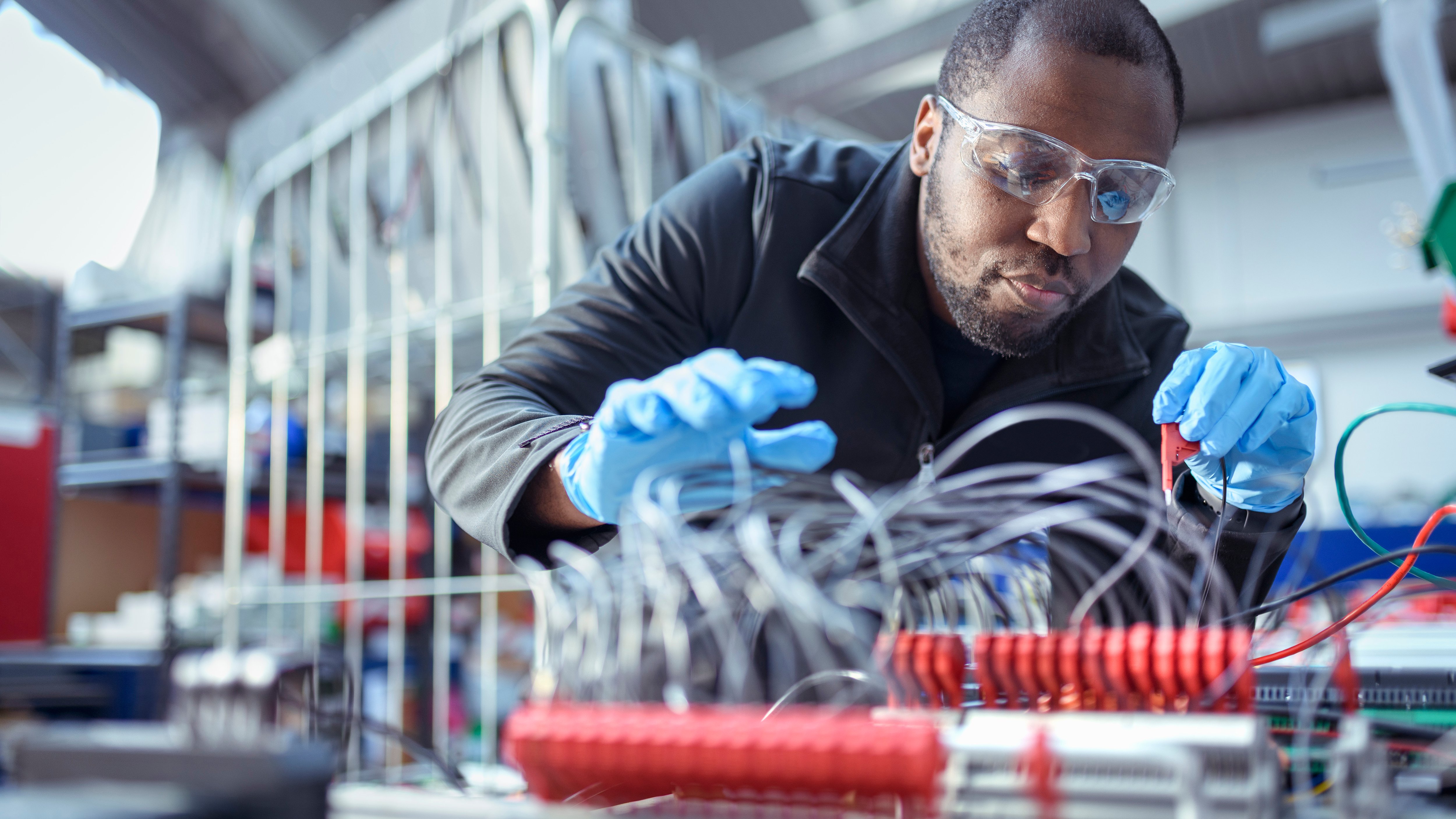 Electrical engineer assembling components in electronics factory