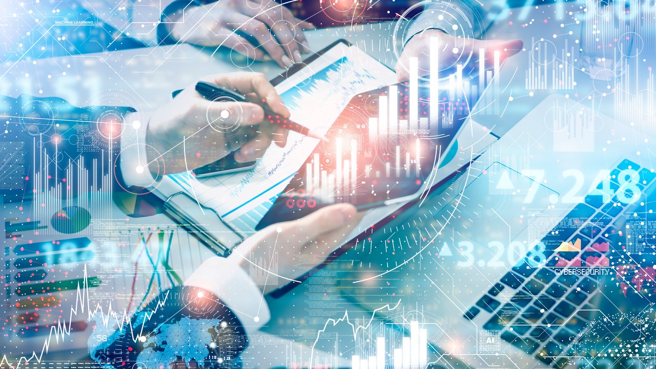 Two people on a laptop and tablet with an overlay of data and graphics