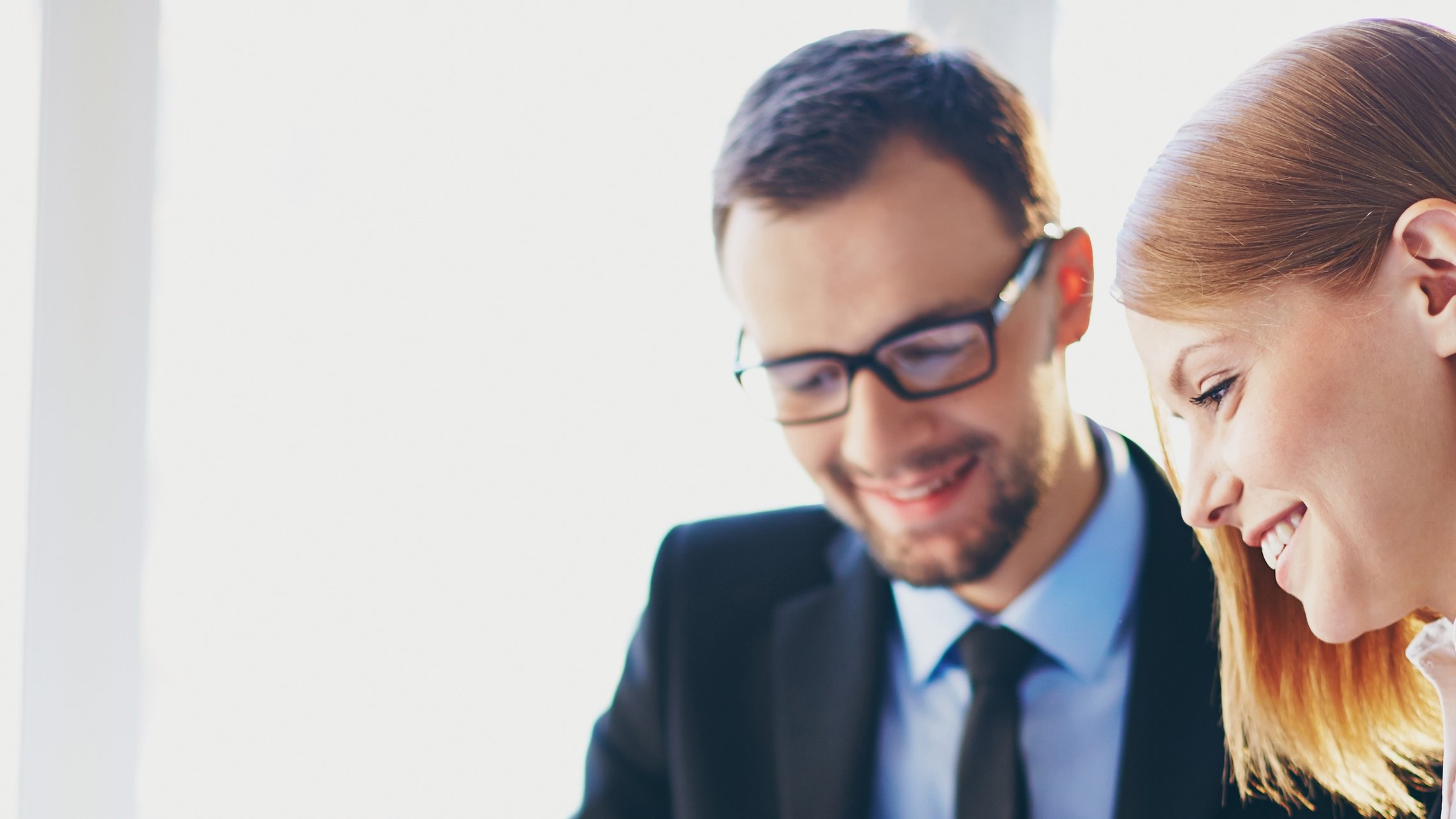 Two insurance professional looking at a computer for commercial lines products