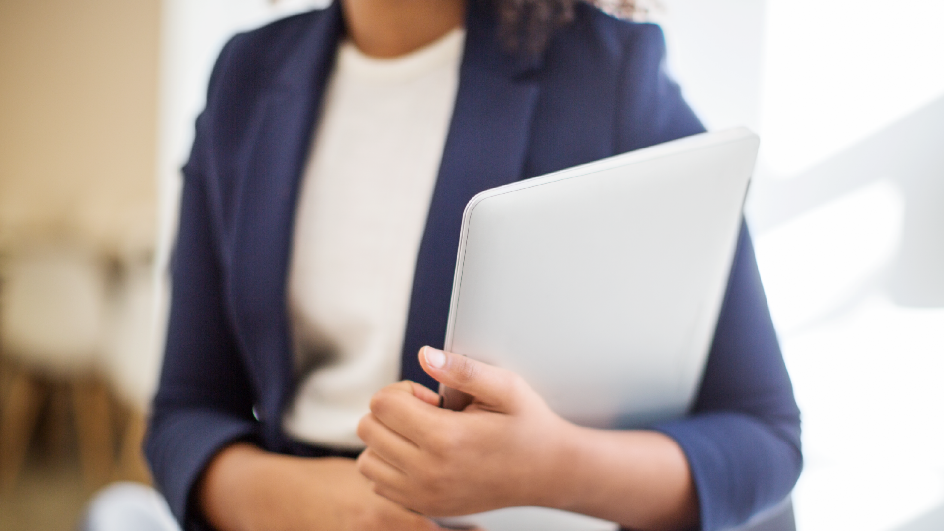 Close up of a female executive holding a laptop