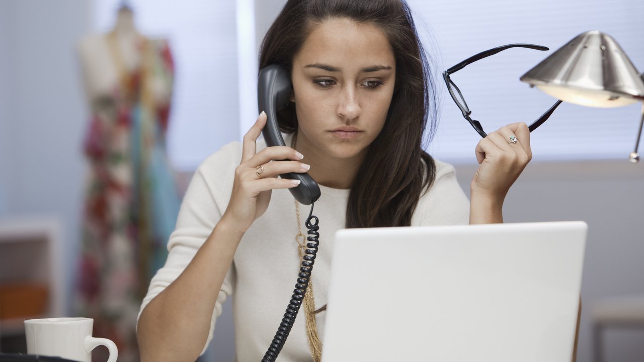 A person at work using a landline phone